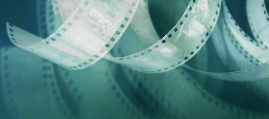 retro film, 35mm film, perforated, negative on pink background, with shadow, photo film, vintage film, film photography, analog film, vintage photography, retro photo