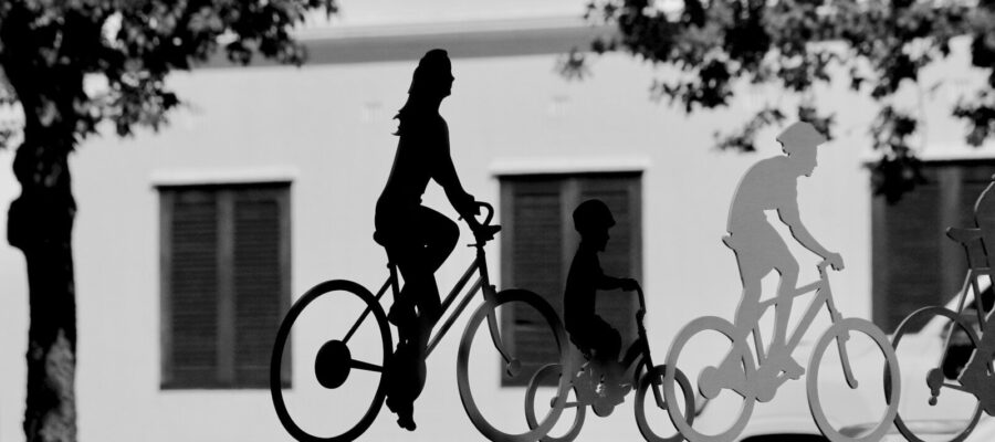 a black and white photo of people riding bikes
