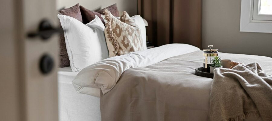 A bed sitting in a bedroom next to a window